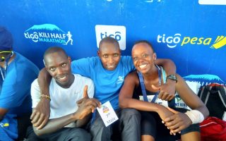 Posing with two of Kenya's Elite Runners at the 2019 Kilimanjaro Marathon